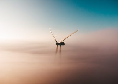 Wind turbine in fog - photo by Sander Weeteling on Unsplash.com
